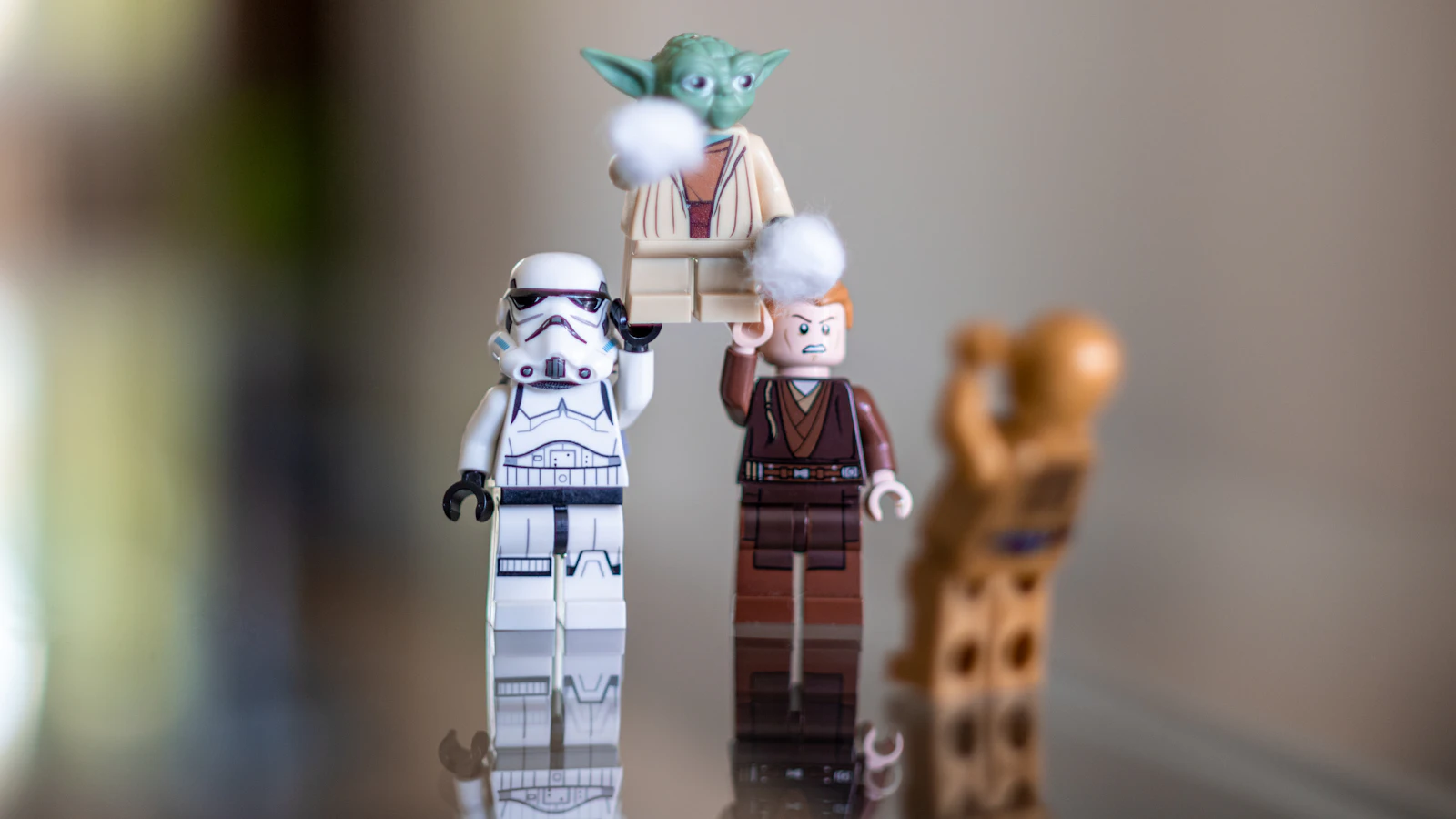 A small LEGO Star Wars minifigure collection arranged on a reflective surface